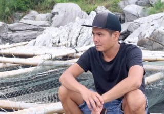Anh Hoàng Ngọc Hân ngồi lặng bên bờ đá. Ảnh: Hải Phương